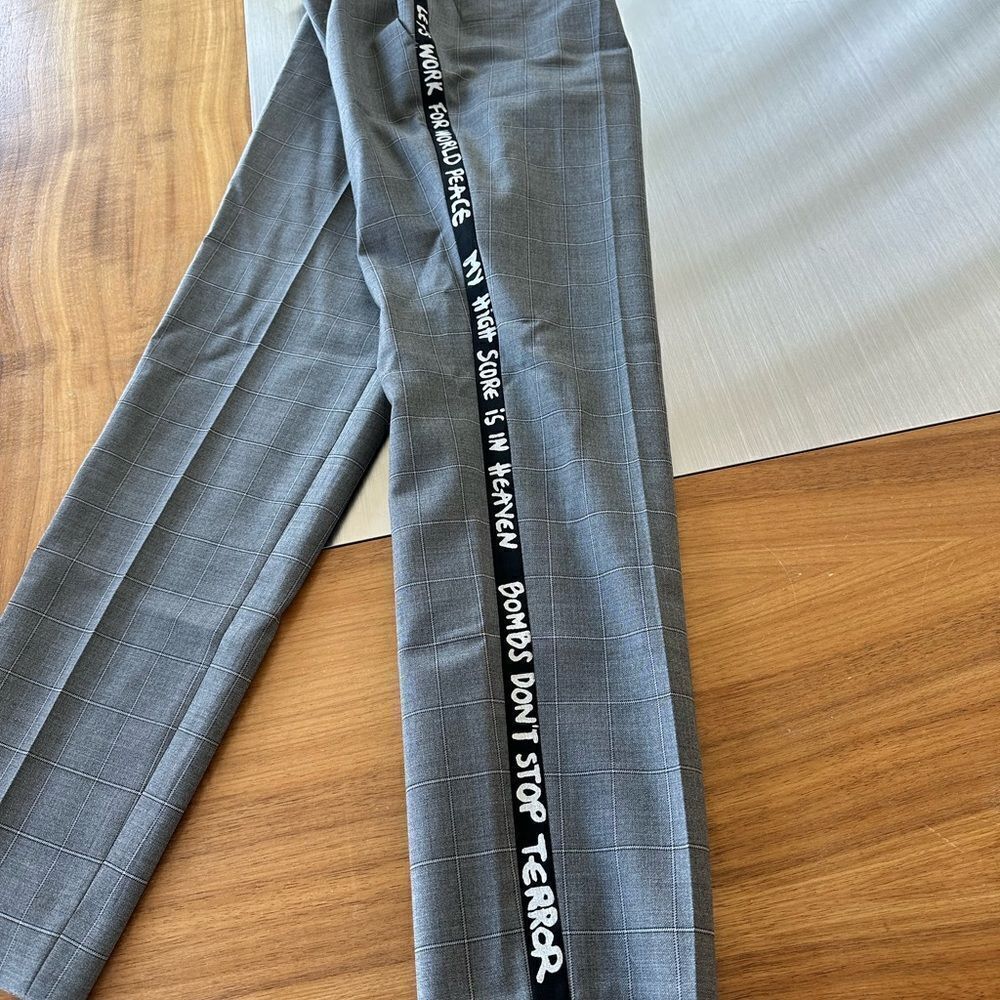 Each Other gray dress pants with writing down the side of the leg in size large